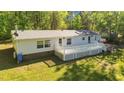 The backyard offers a spacious deck, ideal for outdoor gatherings and relaxation on sunny days at 4500 Governor Hunt St, Efland, NC 27243