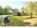 Inviting single story home with covered carport and an expertly landscaped stone and mulch garden at 452 Dogwood Trl, Henderson, NC 27537