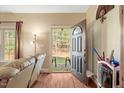 Open foyer welcomes you with hardwood floors and natural light flowing through the doorway at 452 Dogwood Trl, Henderson, NC 27537