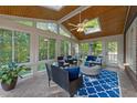 Bright sunroom features skylights, tile flooring, and comfortable seating, perfect for relaxation at 5016 Dillswood Ln, Raleigh, NC 27606
