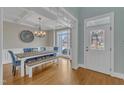 Bright dining room with coffered ceilings, wooden floors, and a window with neighborhood views at 5109 Dove Forest Ln, Apex, NC 27539