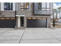 Modern townhome with brick facade, black garage doors, and contemporary address display at 512 Edgecreek Ct, Raleigh, NC 27604