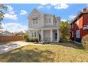 Home exterior with manicured lawn, covered porch, blue door, and ample parking at 512 Montague Ln, Raleigh, NC 27601