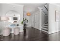 Inviting foyer with dark hardwood floors, staircase, decorative mirror, and elegant lighting at 512 Montague Ln, Raleigh, NC 27601