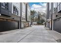 Townhomes featuring black garages and modern architecture line a well-maintained street at 515 Edgecreek Ct, Raleigh, NC 27604