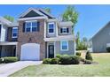 Well-maintained townhome featuring a combination of brick and siding, complemented by a neatly landscaped front yard at 547 Historic Dr, Hillsborough, NC 27278