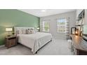 Bright bedroom with a green accent wall, plush carpeting, and ample natural light at 594 Historic Dr, Hillsborough, NC 27278
