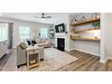 Inviting living room featuring a fireplace, plush sofa, and stylish decor at 594 Historic Dr, Hillsborough, NC 27278