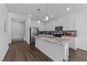 Bright and spacious kitchen with white cabinets, granite countertops, and stainless steel appliances at 608 Creekway Dr, Fuquay Varina, NC 27526