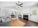 Inviting living room features a cozy fireplace, ceiling fan, and open layout to the dining area at 611 Edenberry Dr, Durham, NC 27713