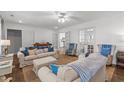 Comfortable living room featuring bright lighting, neutral colors, and cozy couches at 626 Bailey Rd, Coats, NC 27521