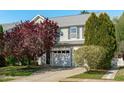 Charming two-story home with a two-car garage, mature landscaping, and a welcoming facade at 712 Wellspring Dr, Holly Springs, NC 27540