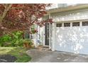 Inviting front entrance with a two-car garage and tastefully landscaped surroundings at 712 Wellspring Dr, Holly Springs, NC 27540