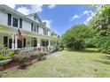 Charming two-story farmhouse with a welcoming porch and beautifully landscaped front yard at 7129 Dexter Rd, Oxford, NC 27565