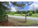 Mailbox showing the street number of the property with a wooded backdrop at 7129 Dexter Rd, Oxford, NC 27565