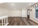 Living room with hardwood floors, closet and large window bringing in natural light at 7324 Summerland Dr, Raleigh, NC 27612