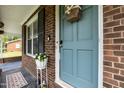 Close-up of a welcoming light blue front door and covered front porch at 7698 Nc Highway 222, Kenly, NC 27542