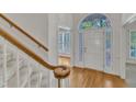 Bright foyer featuring hardwood floors, stairway, and a view into the adjacent living spaces at 8012 Glenbrittle Way, Raleigh, NC 27615