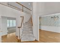 Bright foyer featuring hardwood floors, stairway, and a view into the adjacent living spaces at 8012 Glenbrittle Way, Raleigh, NC 27615
