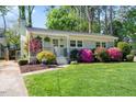 Charming single-story home featuring a well-manicured lawn and mature azaleas, creating a picturesque curb appeal at 806 Edmund St, Raleigh, NC 27604