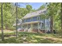 Lovely two-story home with a welcoming porch, surrounded by mature trees at 8407 Millers Bnd, Bahama, NC 27503