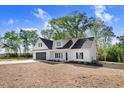 New construction home features a clean white exterior, black shutters and black garage door at 9200 Otter Ct, Middlesex, NC 27557