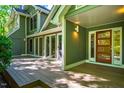 Exterior featuring a deck perfect for outdoor living, glass doors, and a well-maintained facade at 102 Antler Point Rd, Chapel Hill, NC 27516