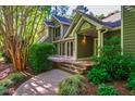 Beautiful home exterior featuring a spacious porch and a lush, green yard at 102 Antler Point Rd, Chapel Hill, NC 27516
