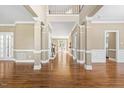 Inviting foyer with soaring ceilings, hardwood floors, and elegant architectural columns at 102 Traviliah Oaks Ln, Cary, NC 27518