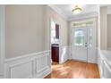 Bright foyer with hardwood floors, decorative trim, and a stylish front door at 103 Aisling Ct, Cary, NC 27513