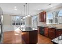Spacious kitchen with a center island, granite countertops, and ample natural light at 103 Aisling Ct, Cary, NC 27513