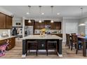 Spacious kitchen boasts granite countertops, stainless appliances, dark cabinets and island seating at 106 Neuse Bluff Cir, Clayton, NC 27527