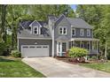 Charming two-story home featuring a well-manicured lawn, inviting front porch and a two-car garage at 110 Chapelwood Way, Cary, NC 27518