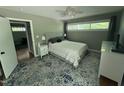 Bright bedroom with large windows, ceiling fan, and stylish rug at 1102 Poplar Ave, Garner, NC 27529