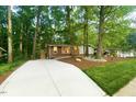 Charming single story brick home surrounded by mature trees and well-maintained landscaping at 1124 Hardimont Rd, Raleigh, NC 27609