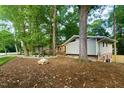 A single Gathering home with brick and light gray wood with a well landscaped yard at 1124 Hardimont Rd, Raleigh, NC 27609