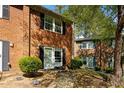 Classic brick townhome with neat landscaping, offering a timeless and welcoming curb appeal at 115 Coleridge Ct, Carrboro, NC 27510
