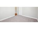 Cozy bedroom with neutral carpet, light gray walls and white door frames at 115 Higbee St, Durham, NC 27704