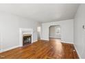 Bright living room features hardwood floors and a decorative fireplace with white mantle at 115 Higbee St, Durham, NC 27704