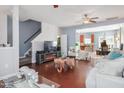 Cozy living room with hardwood floors, fireplace, stairs, and a view into the adjacent kitchen at 1304 Cozart St # 216, Durham, NC 27704