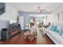 A bright living area boasts hardwood floors, contemporary decor, and an open flow to the kitchen at 1304 Cozart St # 216, Durham, NC 27704
