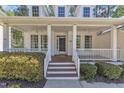 Inviting covered porch with ceiling fans and lovely views at 1420 Willowleaf Way, Apex, NC 27502