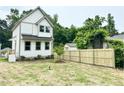 The backyard features a wooden fence and a young tree, offering a private outdoor space at 1448A Maplewood Dr, Durham, NC 27704