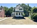Attractive house features a gray and white exterior and professionally landscaped front yard at 1448A Maplewood Dr, Durham, NC 27704