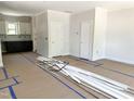 View of an unfinished interior space, revealing the layout of the home with doorways and kitchen space at 1448A Maplewood Dr, Durham, NC 27704