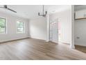 Bright living room with sleek hardwood floors, modern lighting, and ample natural light at 1448A Maplewood Dr, Durham, NC 27704