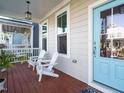 Relax on this charming front porch with two white Adirondack chairs and a bright blue door at 1517 Millrock Trl, Wendell, NC 27591