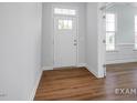 Bright entryway features wood-look flooring and a windowed front door that welcomes you into the home at 152 Cultivator Ct, Angier, NC 27501