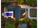 Aerial view of the property showcasing the layout, pool, driveway, and lush landscaping at 1616 Hunting Ridge Rd, Raleigh, NC 27615