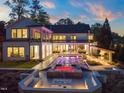 A luxury backyard featuring a stunning pool, jacuzzi, and outdoor kitchen, perfect for entertaining friends and Gathering at 1616 Hunting Ridge Rd, Raleigh, NC 27615